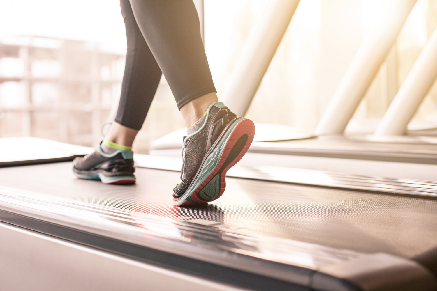 A closer view of shoes worn by someone running on a treadmill