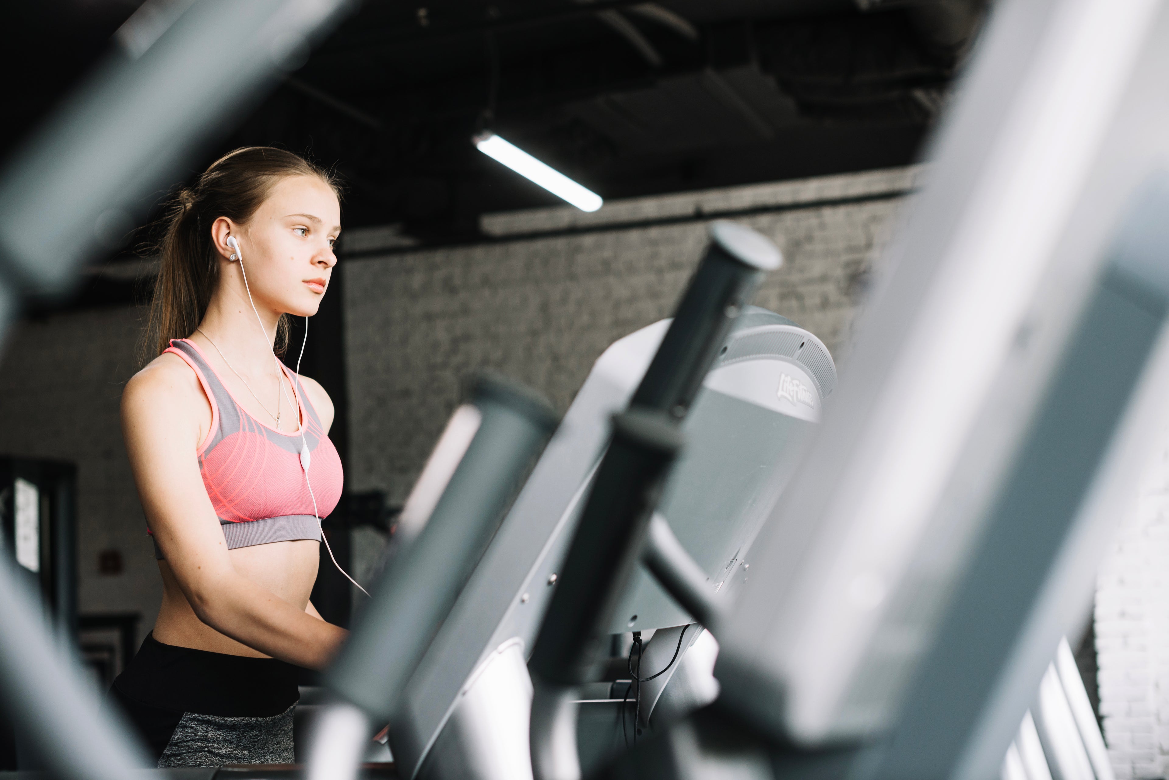 Girl listening to music while on a treadmill
